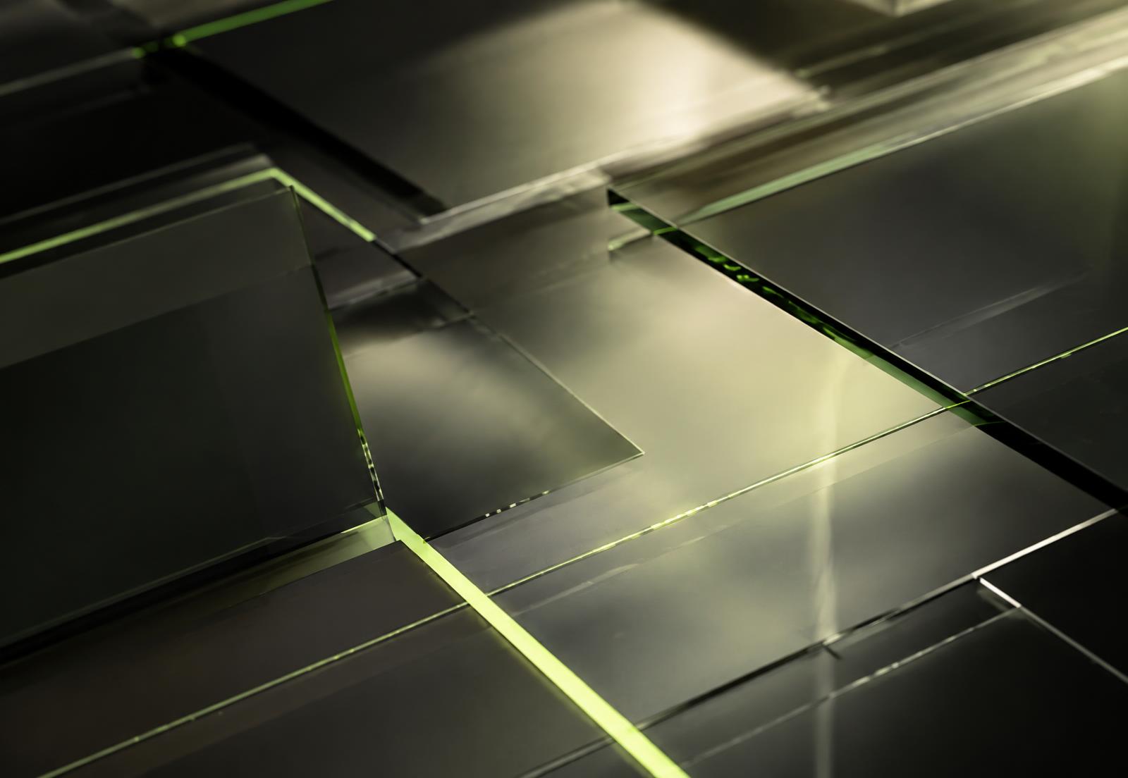 Abstract composition of dark graphite glass panels separated by glowing electric lime lines